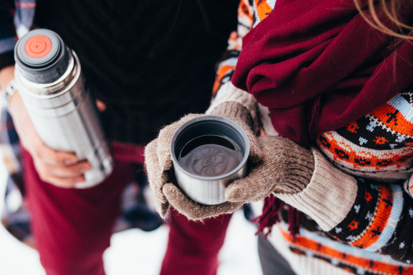 Women drinks coffee from a thermos