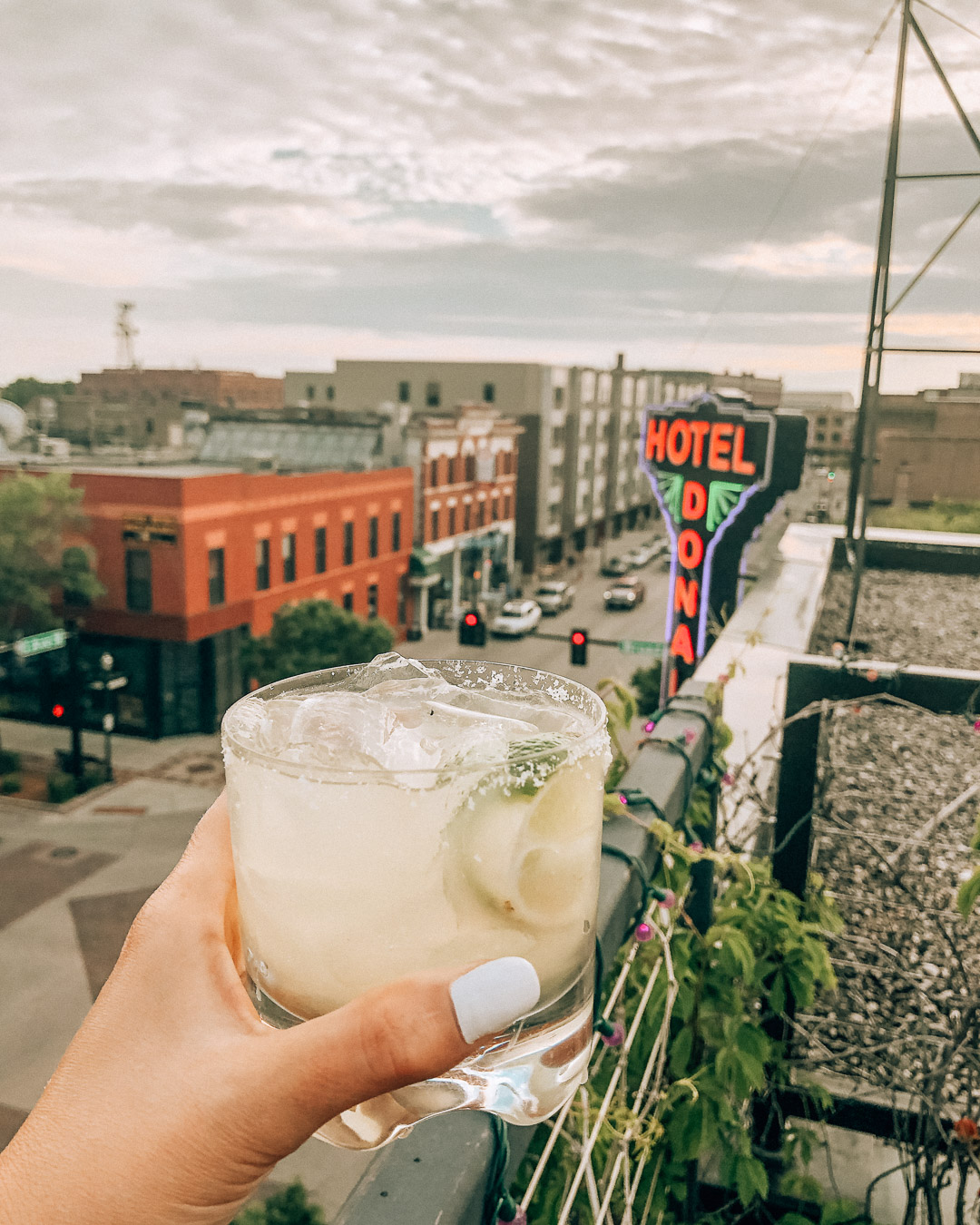 Having drinks on the rooftop bar at Hotel Donaldson Fargo North Dakota overlooking the city at sunset